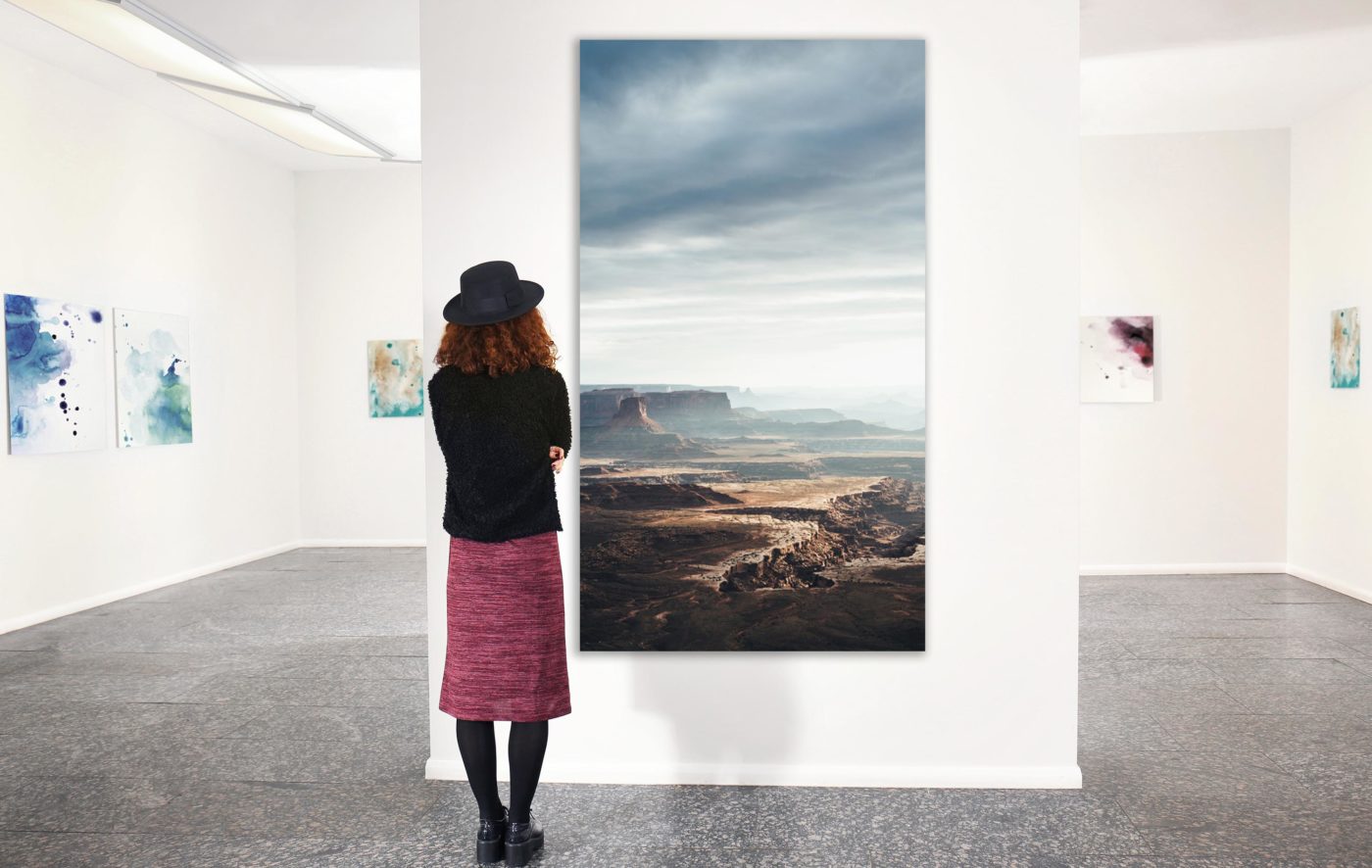 woman standing in front of large vertical photo