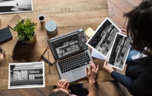 two people looking over photos